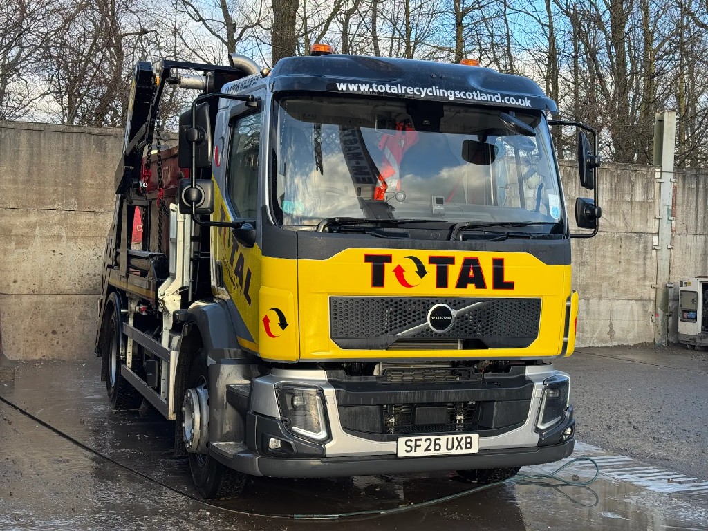 Total Recycling Scotland yellow Volvo skip loader truck at the depot